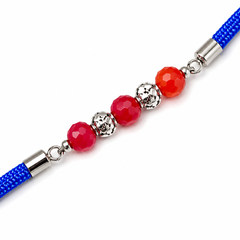 Red-Orange Crystal 92.5 Silver Rakhi on Royal Blue Cord