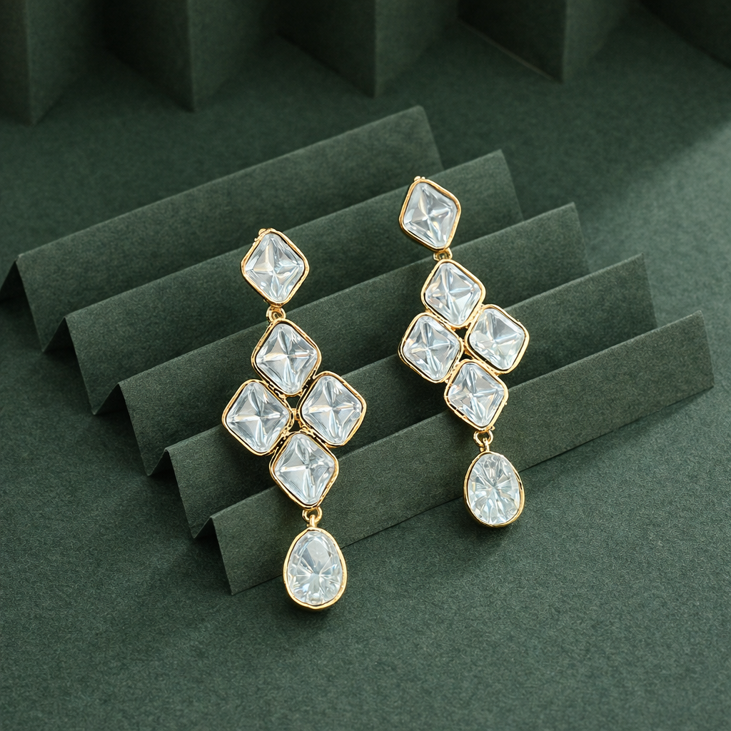 Close up of clear stone detailing on Rangrez gold finish drop earrings