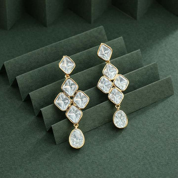 Close up of clear stone detailing on Rangrez gold finish drop earrings