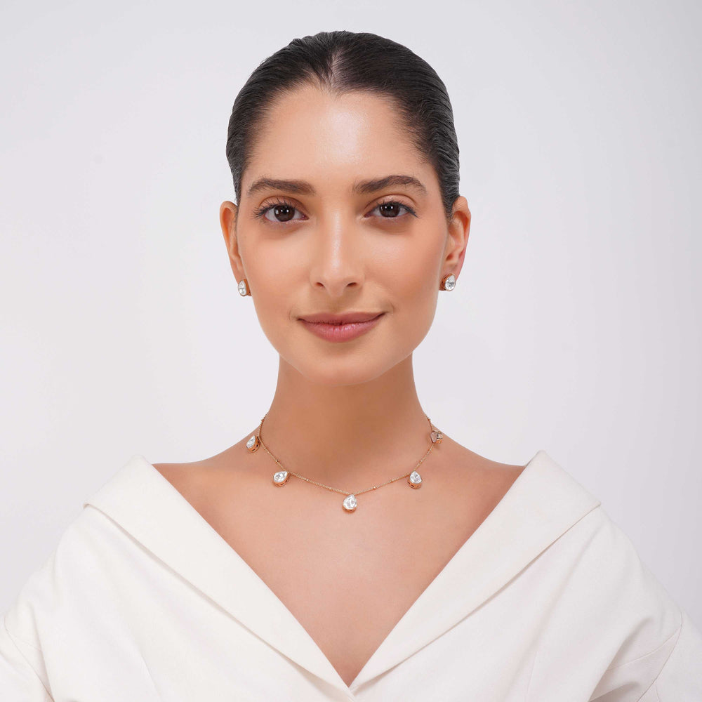 Close up of Rangrez teardrop stone detailing on gold finish necklace