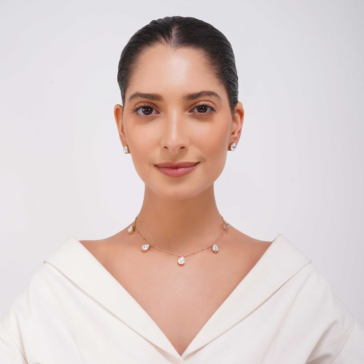 Close up of Rangrez teardrop stone detailing on gold finish necklace